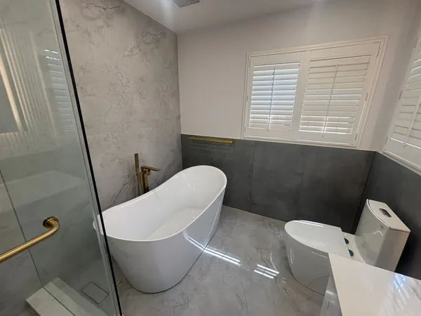 Marble tile bathroom warm gold fixtures Mississauga